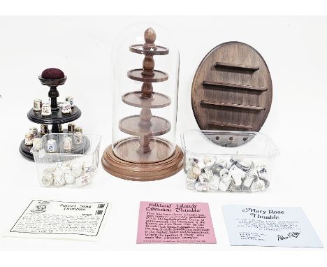 Collection of thimbles, mainly ceramic including set of fifteen Royal Crown Derby thimbles on a wooden stand with integral pi