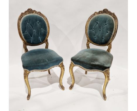 Pair of French giltwood salon chairs in the Louis XVI manner, the frames of the oval backs carved with flowers and ribbons, b
