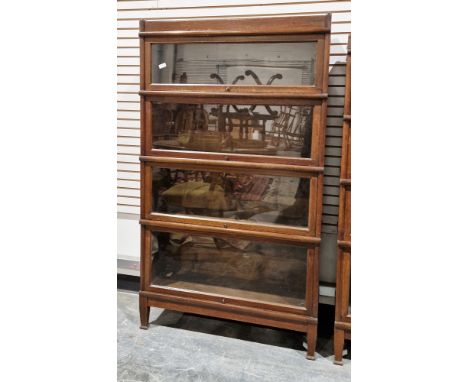 Early 20th century Globe Wernicke oak sectional stacking bookcase&nbsp;comprising four up and over glazed doors and raised on