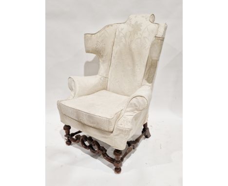 Cream upholstered armchair&nbsp;in the 17th century William and Mary style, raised on a carved walnut base with cup and cover