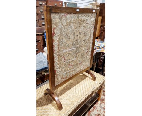 Early 20th century oak framed metamorphic table/firescreen&nbsp;inset with a silk and metallic thread panel depicting flowers