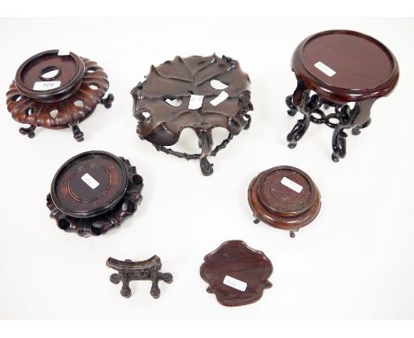 Group of early 20th century and later Chinese carved hardwood stands, including a small carved fretwork disc stand, a stand c