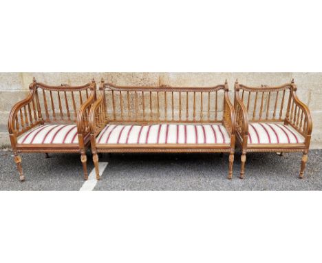 Walnut settee and two matching armchairs in the Louis XVI manner, each piece with top rails having carved floral and leaf dec