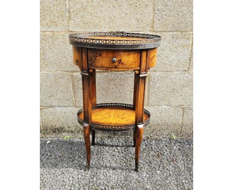 Theodore Alexander lamp table&nbsp;in the Louis XVI manner, burr maple of oval form with pierced gilt metal gallery rail to t