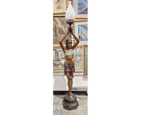 Cast bronze standard lamp&nbsp;in the form of a 1920's dancing girl holding a glass flame torch above her head, on an octagon