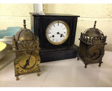 A late 19th century slate cased mantle clock together with two small lantern clocks.