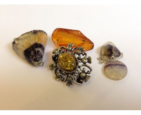 A Blue John marble pendant together with two polished similar items, a piece of amber (8 grams) and an amber set silver metal