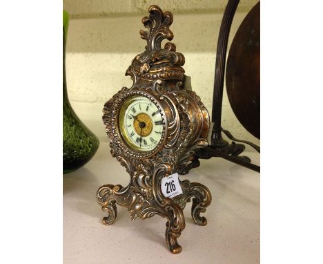 A copper cased Rococo style mantle clock.