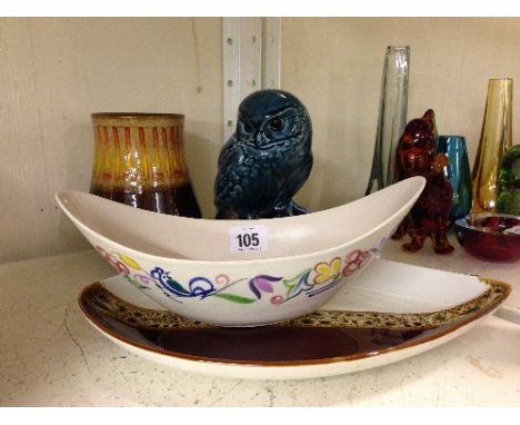 A Poole Pottery blue glazed model of a Little Owl together with three other Poole items.