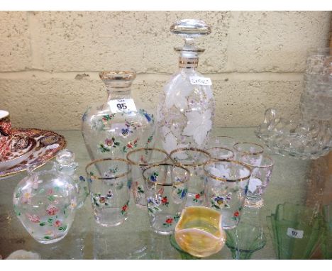 An enamel decorated glass part liqueur set together with other decorated glass items.