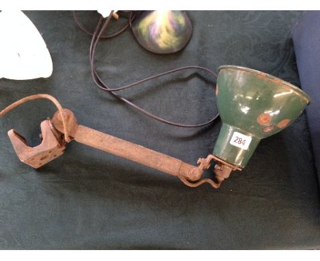 An industrial angle poise lamp with green enamel shade.