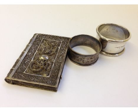 Two silver serviette rings together with a pierced Chinese silver card case, decorated with a Dragon, signed with initials WH