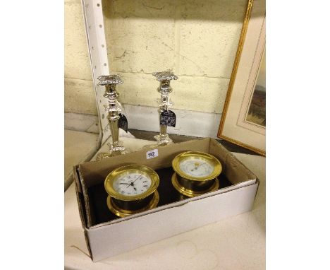 A pair of modern silver plated candlesticks together with a barometer and clock set.