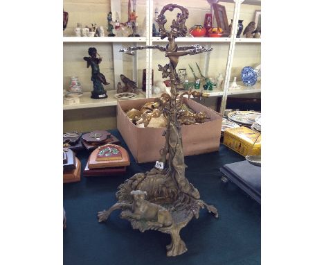 A brass stick stand decorated with a Dog seated under a tree with rifle resting alongside.