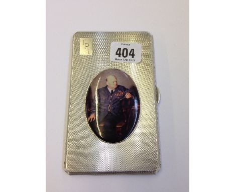 An engine turned silver cigarette case, decorated with a portrait medallion of Sir Winston Churchill (264 grams overall).