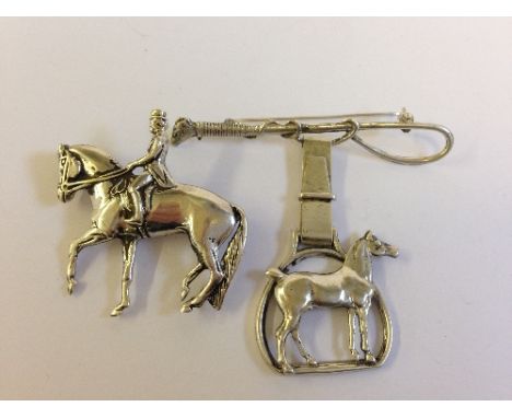 Two silver horse brooches.