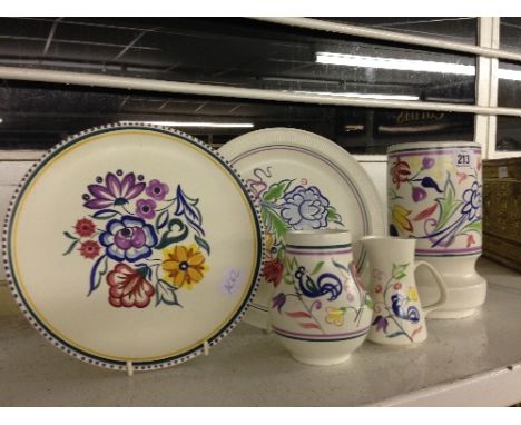 Five various white bodied Poole Pottery items.