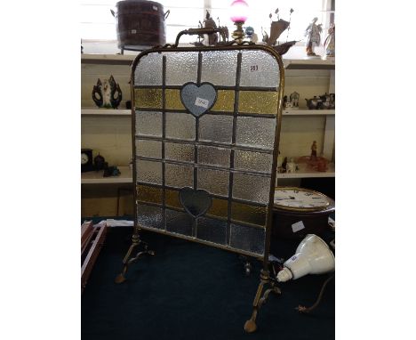 An early 20th century leaded glass brass framed fire screen.