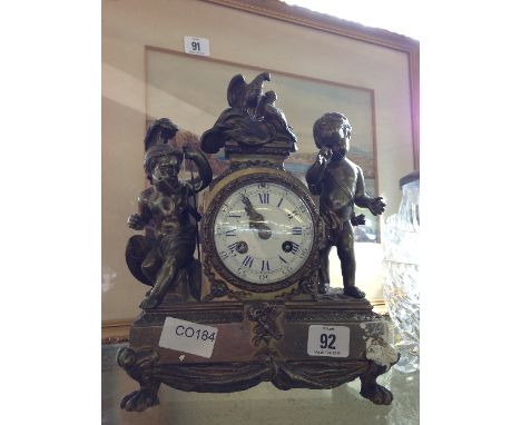 A late 19th century French brass cased mantle clock mounted with two figures of Children dressed as Centurion and Cupid with 