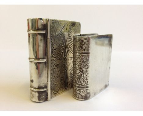 Two silver pill boxes modelled as books.
