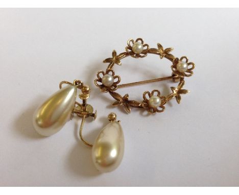 A 9 carat gold brooch set with four pearls together with a pair of pearl drop earrings.