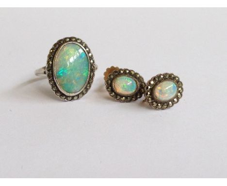 A silver and marcasite opal set ladies dress ring together with a pair of matching earrings.