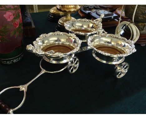 A silver plated triple cart table coaster set.