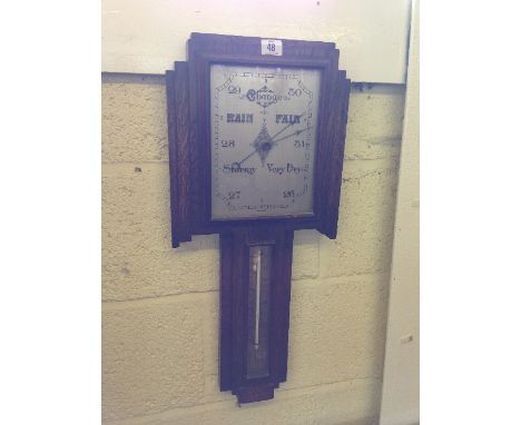 An Art Deco oak cased wall barometer.