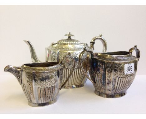 A three piece early 20th century three piece late Victorian silver plated teaset with engraved decoration.