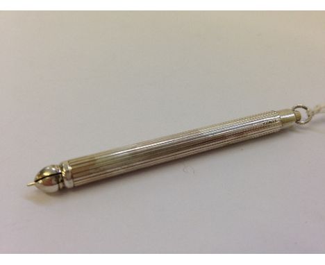 An early 20th century retractable silver tooth pick.