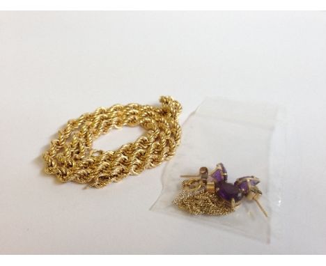 A 9 carat gold rope necklace (9.8 grams) together with an amethyst and yellow metal pendant and earring set.