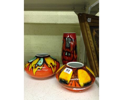 A Poole Pottery Delphis vase, shape 15, decorated in an abstract pattern in tones of orange, blue and red together with two s