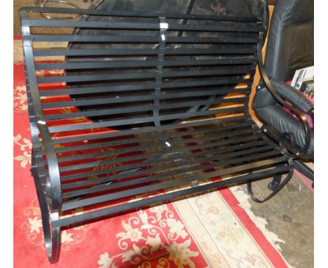 A wrought iron garden bench