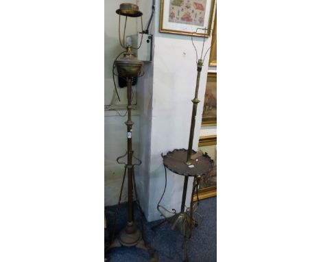 A brass telescopic standard lamp with integral copper mid height shelf together with another copper telescopic standard lamp 