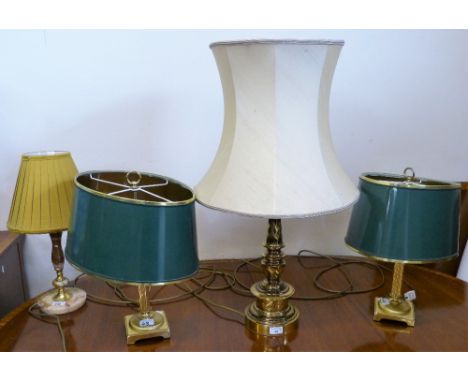 A pair of brass column twin branch table lamps with green shades, a brass table lamp with cream shade and a marble effect tab