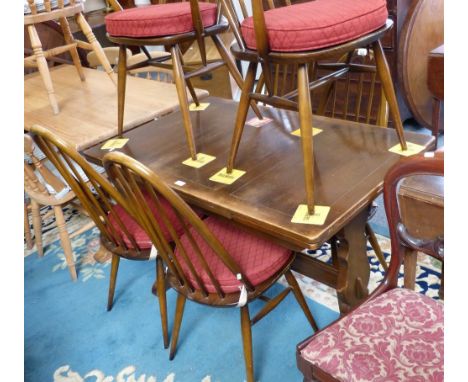 An Ercol oak dining suite comprising refectory style draw-leaf table, 71cm x 174cm extended to include two leaves and set of 