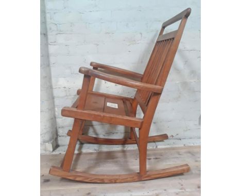 A Scottish Arts & Crafts elm rocking chair, labelled 'Caithness Chairs Hand Made in Thurso'. 