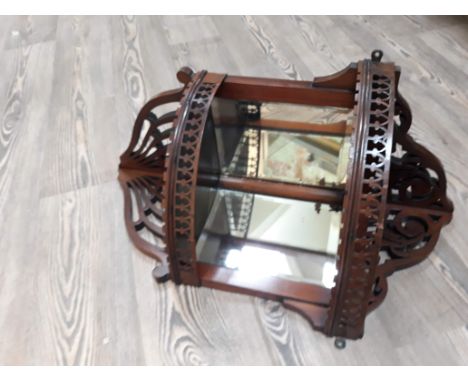 An Edwardian mirror corner shelf.