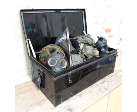 A military metal trunk and contents including three gas masks, various military clothing, flag, billy cans etc.  
