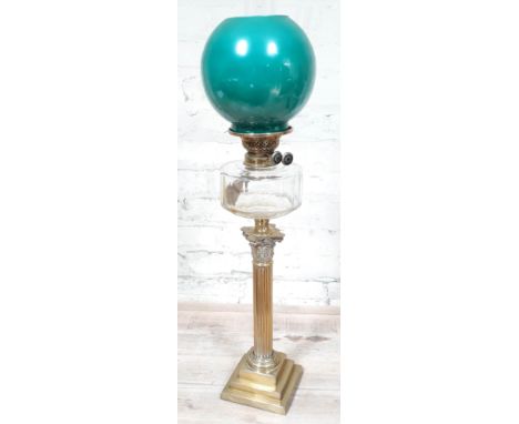 A brass Corinthian column oil lamp with green glass shade and glass funnel, height 82cm.  Condition: glass ok, minor surface 