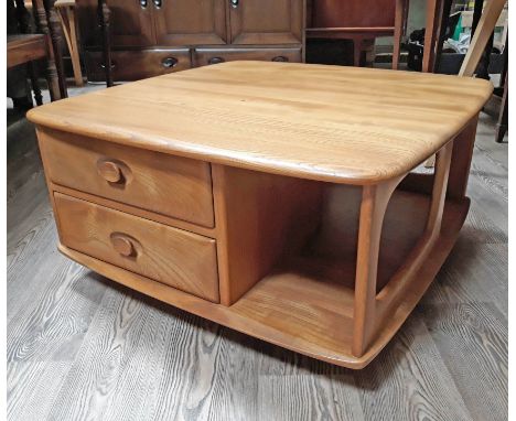 An Ercol light elm and beech coffee table with two drawers. 