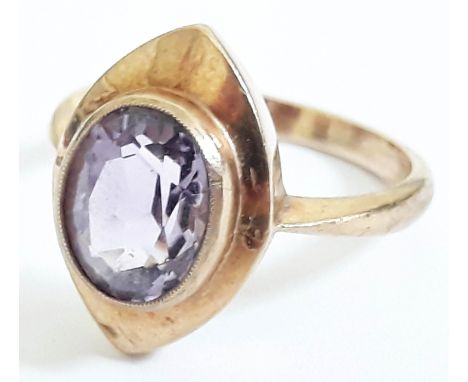 A 9ct gold ring set with an amethyst coloured stone, marked '9ct', gross wt. 3.7g, size O. 