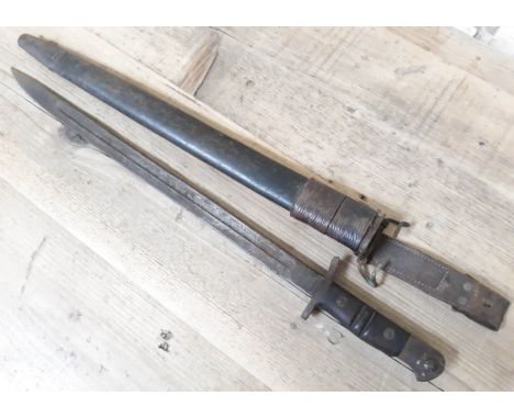 A WWI bayonet.Condition: blade length - 43cm, scabbard length 46cm, very tip of blade slightly bent, some signs of corrosion/