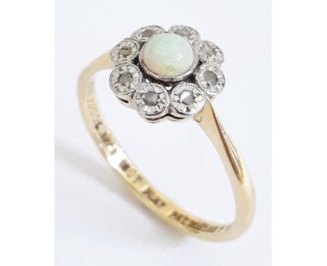 A 1930s diamond and opal cabochon flower head ring, marked '18ct' & 'PLAT', gross wt. 2.6g, size M. 