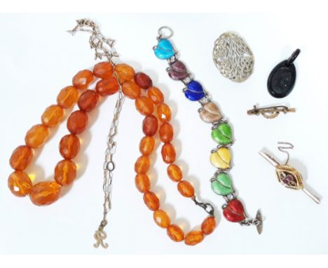 A mixed lot of jewellery comprising an facetted amber bead necklace, a a hallmarked silver and enamel bracelet, two yellow me