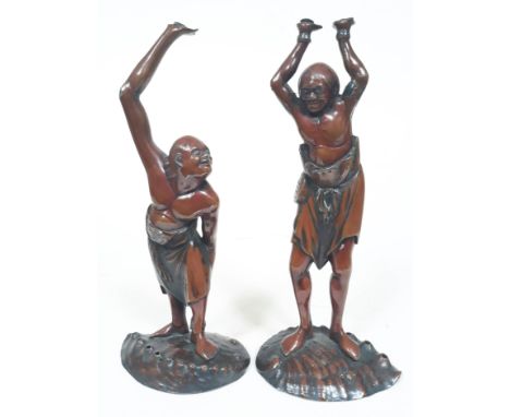 A pair of Japanese Meiji Period Miyao style lacquered metal Okimono depicting men stood on shell bases, height 26cm. Conditio