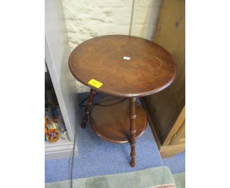 A late 19th century mahogany circular, two tier table having three turned legs, 19 1/4"h x 15"w 