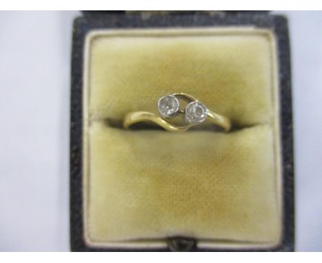 An 18ct gold and two diamond crossover ring 