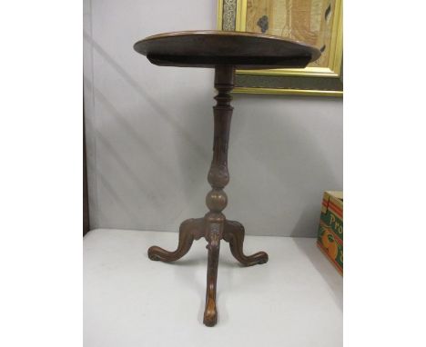 A Victorian walnut pedestal table with a turned, carved column on a tripod base 