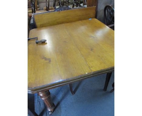 A Victorian mahogany extending dining table with winder 